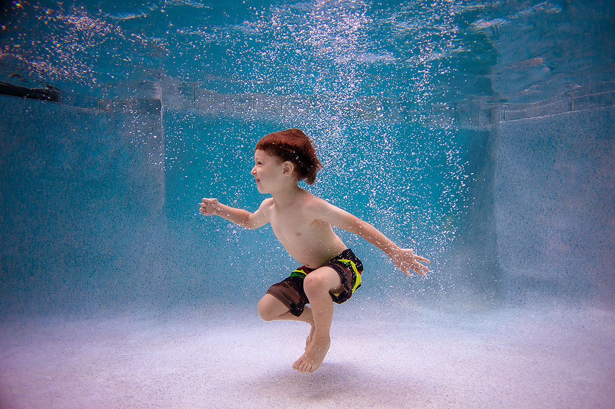 boy playing in swimming pool